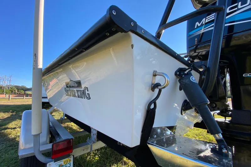 Slide: The Image of 1999 Silver King Signature 16 boat interior with white truck in background. - 17