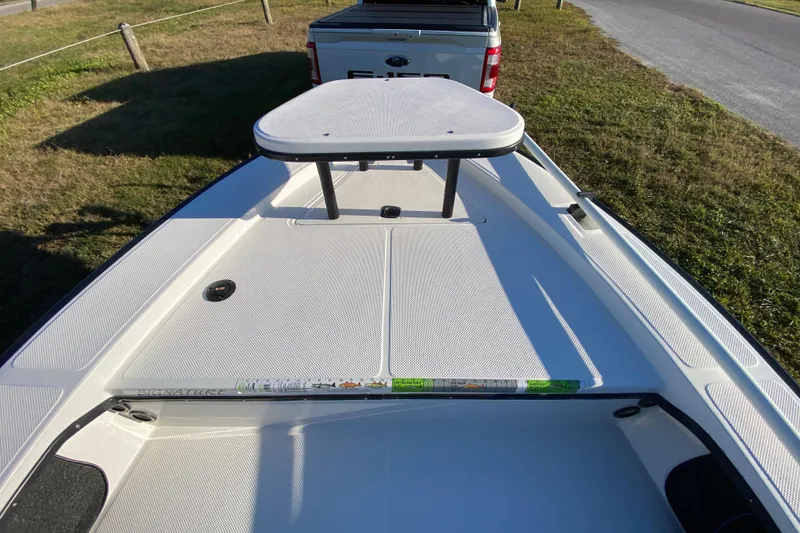 Slide: The Image of 1999 Silver King Signature 16 boat with T-top, parked near a road under clear blue sky. - 21
