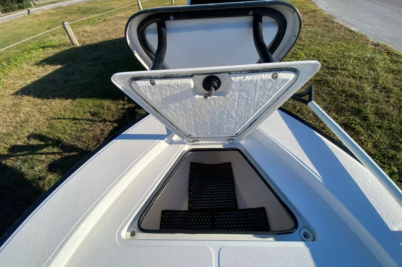 Slide: The Image of Interior view of a 1999 Silver King Signature 16 boat, showcasing clean deck and storage. - 26