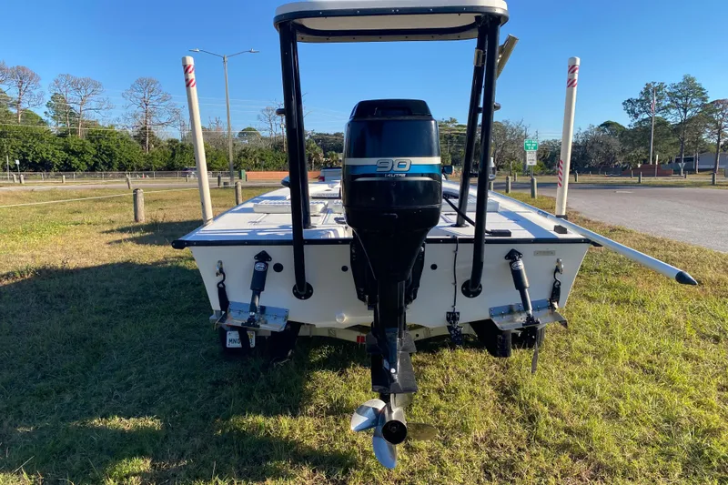 Slide: The Image of 1999 Silver King Signature 16 boat on trailer, parked outside a garage. - 3