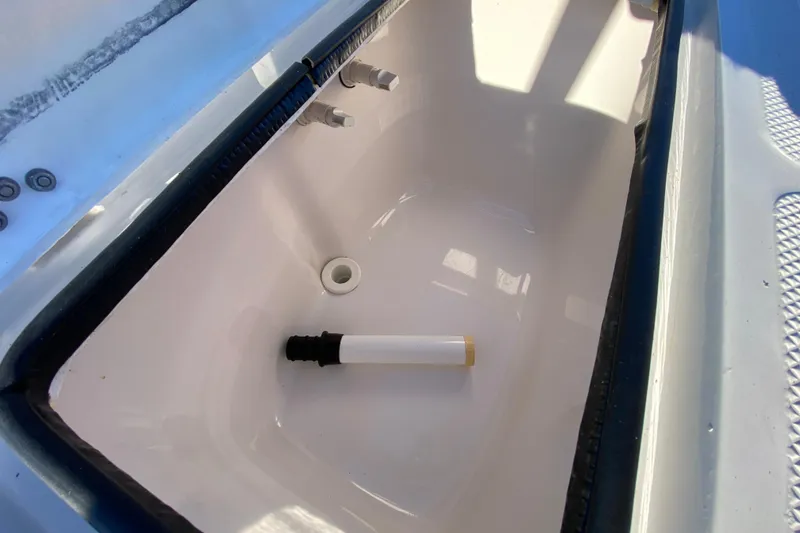 Slide: The Image of Outboard motor on a 1999 Silver King Signature 16 boat, parked outdoors. - 48