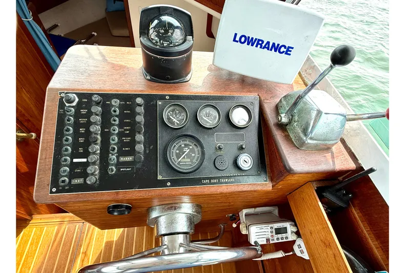 Slide: The Image of 1985 Cape Dory 28 Power Yacht helm with compass, gauges, and Lowrance equipment. - 10