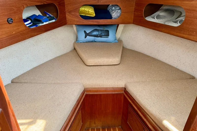 Slide: The Image of Cozy cabin interior of 1985 Cape Dory 28 Power Yacht with beige cushions and wooden accents. - 15