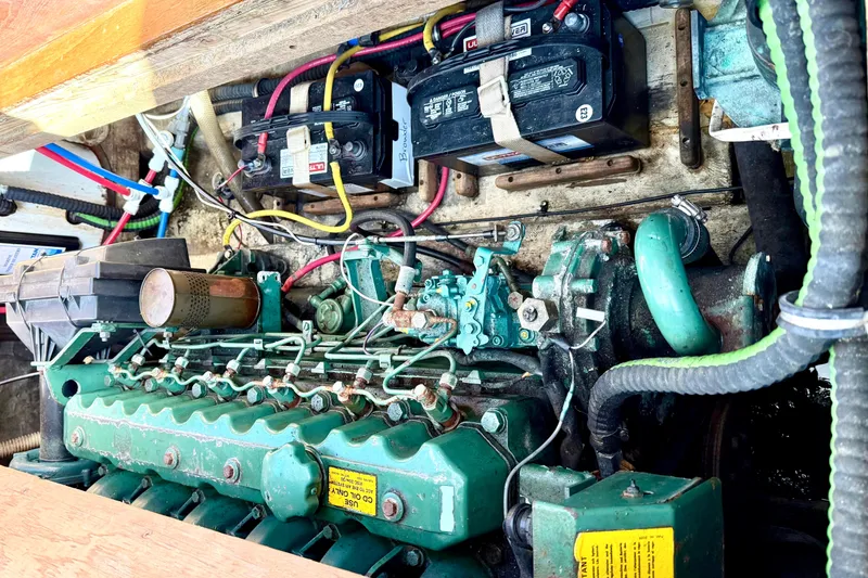 Slide: The Image of Engine compartment of a 1985 Cape Dory 28 Power Yacht, showcasing batteries and mechanical components. - 16