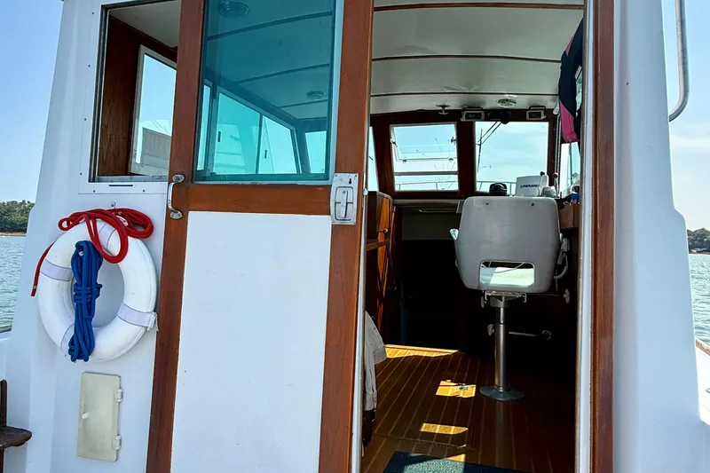 Slide: The Image of 1985 Cape Dory 28 Power Yacht interior with wooden accents and life preserver. - 4