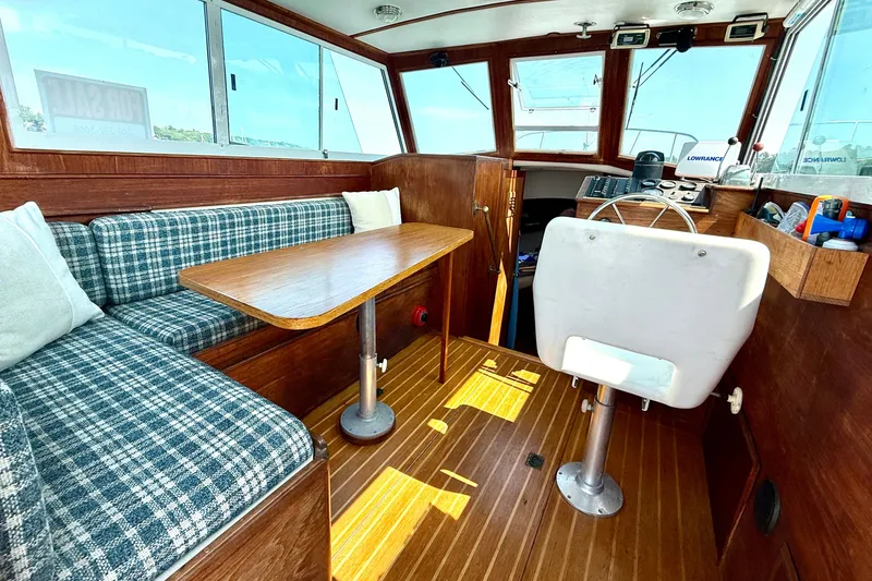 Slide: The Image of Interior of 1985 Cape Dory 28 Power Yacht with wood finish and plaid seating. - 5