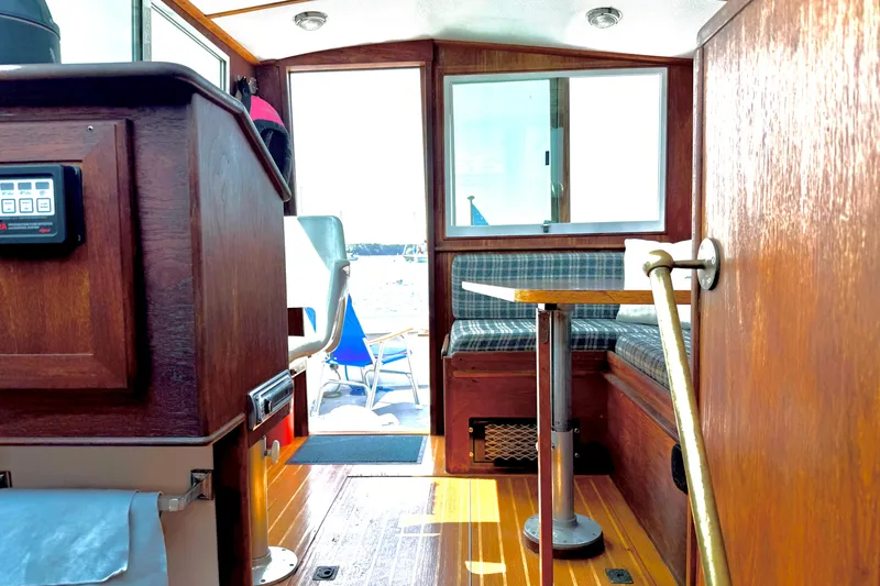 Slide: The Image of Interior of 1985 Cape Dory 28 Power Yacht with wood finish and seating area. - 7