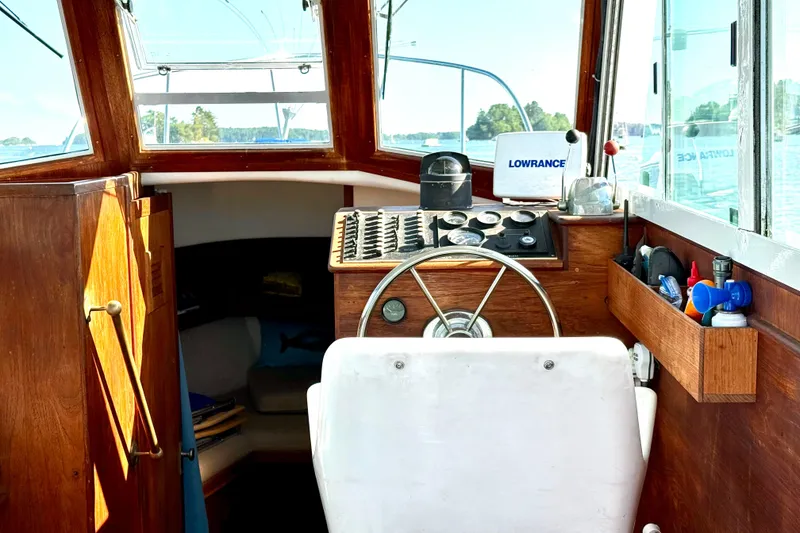 Slide: The Image of 1985 Cape Dory 28 Power Yacht helm with wooden interior and navigation equipment. - 8