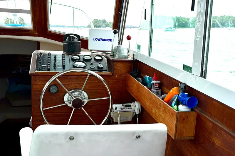 Slide: The Image of 1985 Cape Dory 28 Power Yacht helm with steering wheel and navigation equipment. - 9