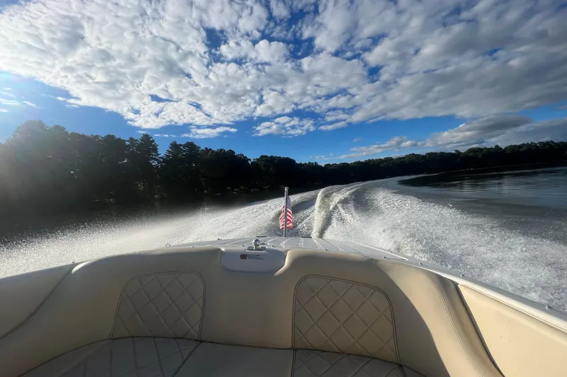 Slide: The Image of 2015 Chris-Craft Lancer 20 cruising on a lake under a partly cloudy sky. - 3