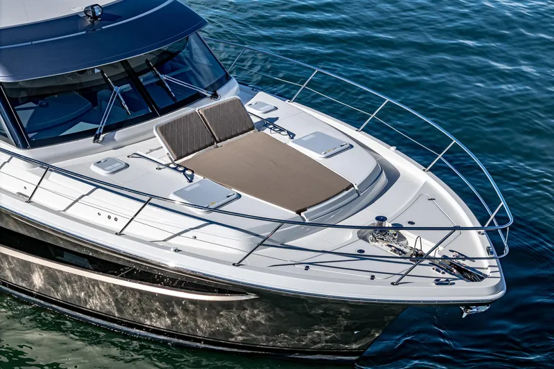 Slide: The Image of 2024 Riviera 465 SUV luxury yacht on water, featuring sunbathing deck. - 11