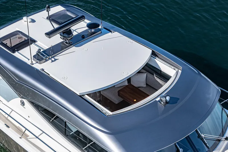 Slide: The Image of 2024 Riviera 465 SUV luxury yacht with spacious upper deck and modern design. - 14