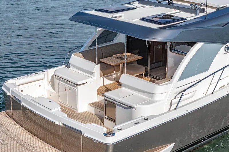 Slide: The Image of 2024 Riviera 465 SUV luxury yacht with spacious deck and modern amenities. - 16