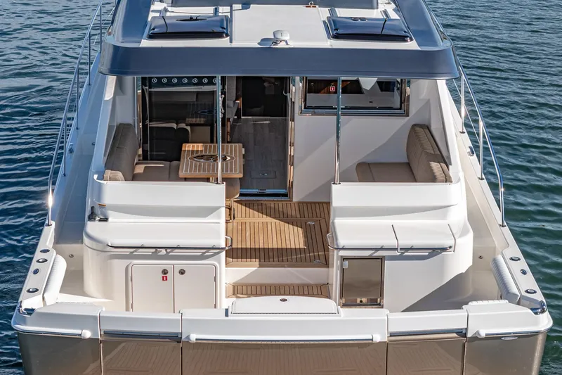 Slide: The Image of 2024 Riviera 465 SUV luxury yacht with spacious deck and seating area. - 17