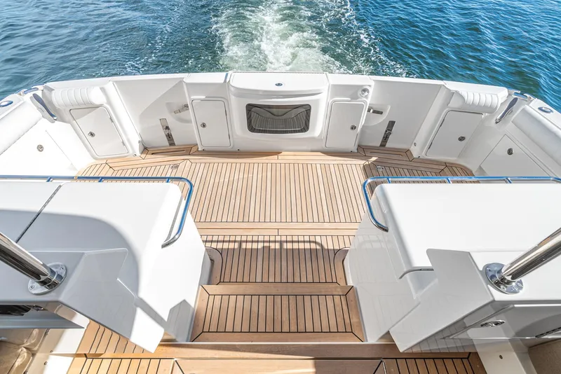 Slide: The Image of 2024 Riviera 465 SUV boat deck with teak flooring and ocean view. - 19