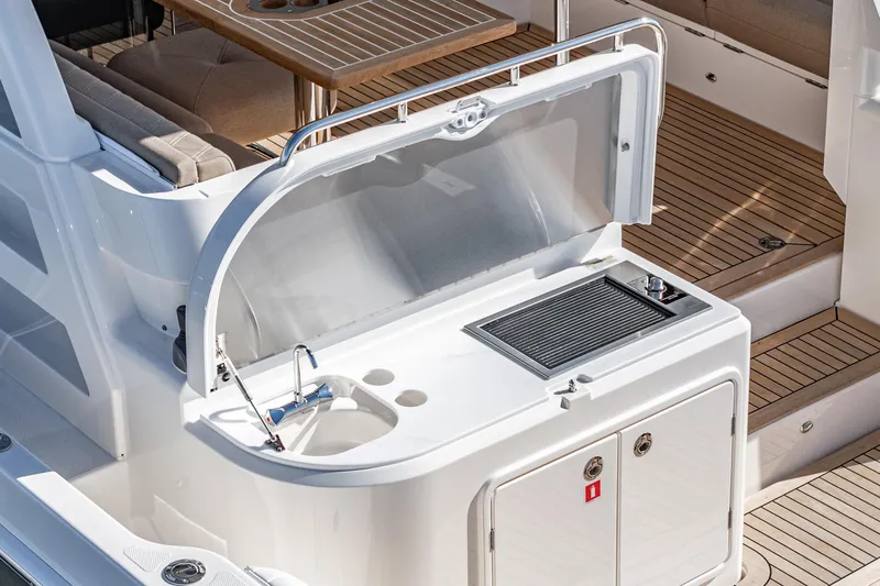 Slide: The Image of 2024 Riviera 465 SUV yacht outdoor kitchen area with sink and grill. - 20