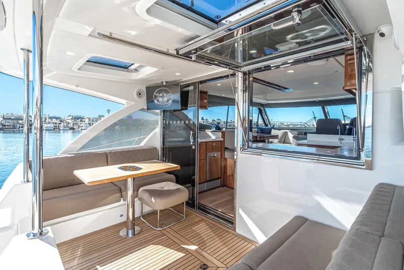 Slide: The Image of 2024 Riviera 465 SUV luxury yacht interior with seating and dining area. - 23