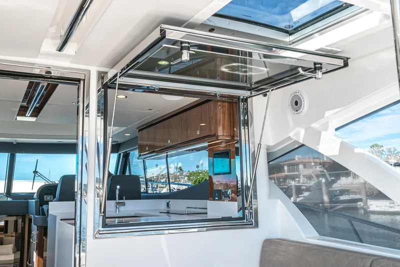 Slide: The Image of 2024 Riviera 465 SUV interior with modern kitchen and panoramic windows. - 25