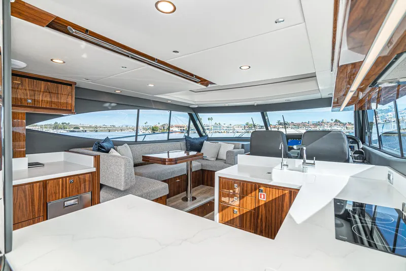 Slide: The Image of 2024 Riviera 465 SUV yacht interior with modern kitchen and spacious seating area. - 29