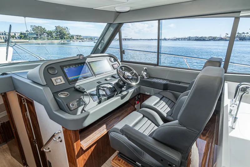 Slide: The Image of 2024 Riviera 465 SUV helm station with dual seats and advanced navigation system. - 34