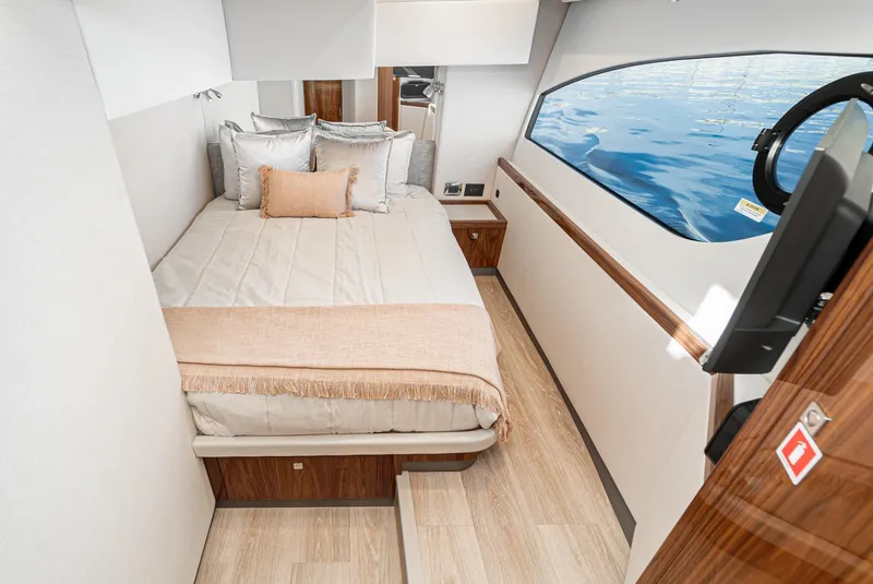Slide: The Image of 2024 Riviera 465 SUV bedroom with ocean view, luxurious bedding, and modern interior design. - 41