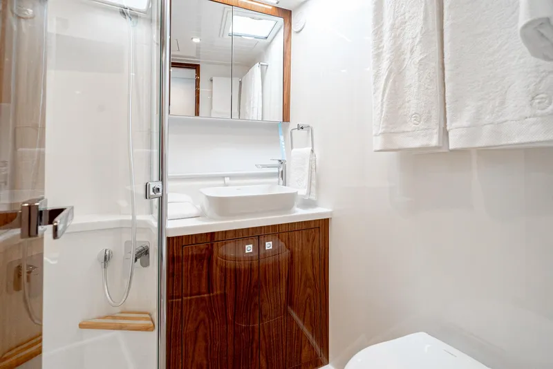 Slide: The Image of Modern bathroom in 2024 Riviera 465 SUV yacht with sleek design and wooden cabinetry. - 42
