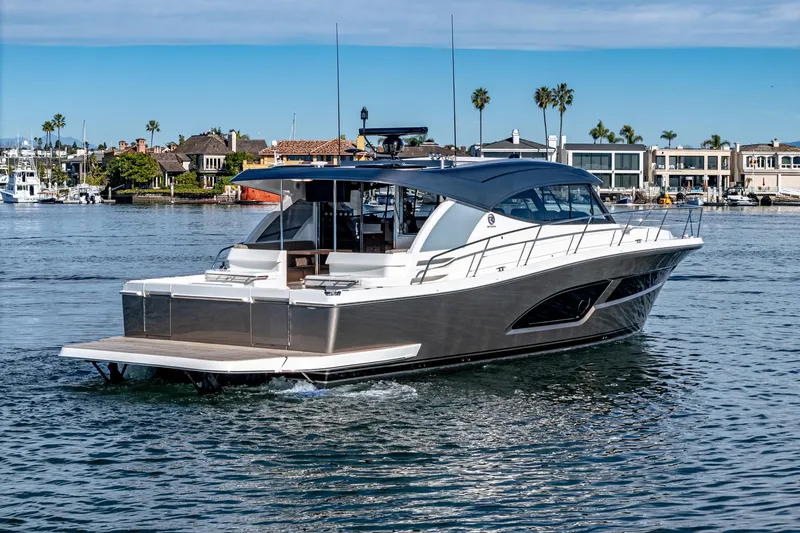 Slide: The Image of 2024 Riviera 465 SUV luxury yacht cruising in a marina. - 6