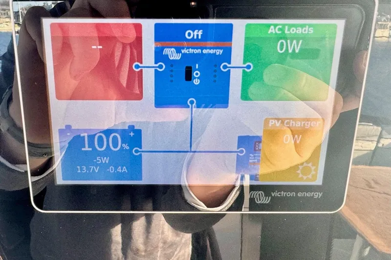 Slide: The Image of Touchscreen display on 2024 Jeanneau NC 1095 Coupe Series 2 showing Victron Energy system status. - 16