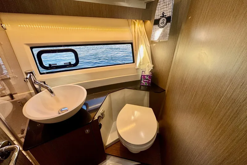 Slide: The Image of 2024 Jeanneau NC 1095 Coupe Series 2 bathroom with modern sink and sea view window. - 21