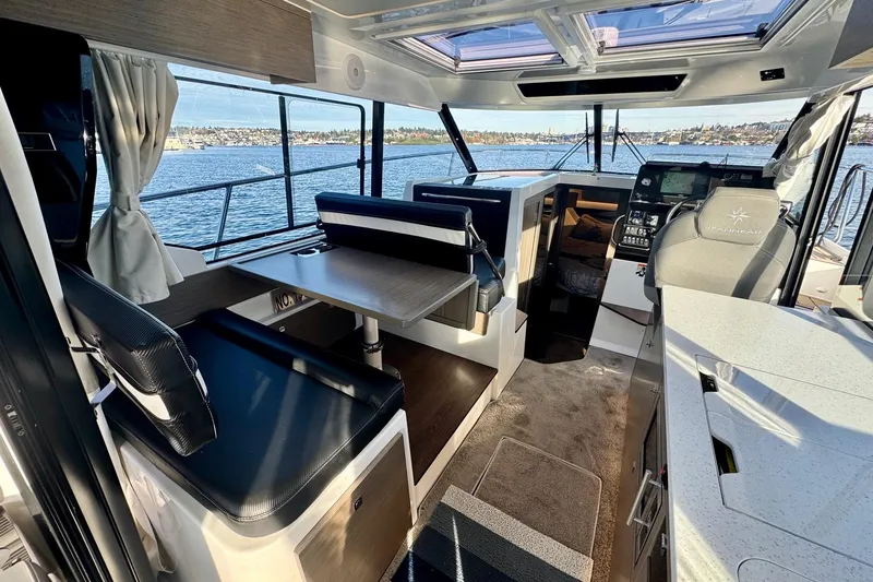 Slide: The Image of Interior of 2024 Jeanneau NC 1095 Coupe Series 2, featuring modern seating and navigation area. - 8