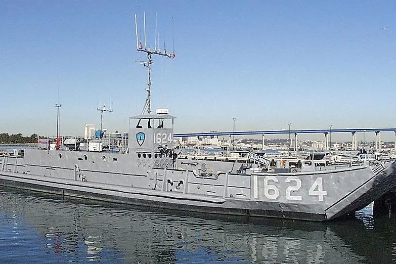 The Image of 1970 COMMERICAL BOAT LCU-135 docked, displaying number 1624, with cityscape background. - 0