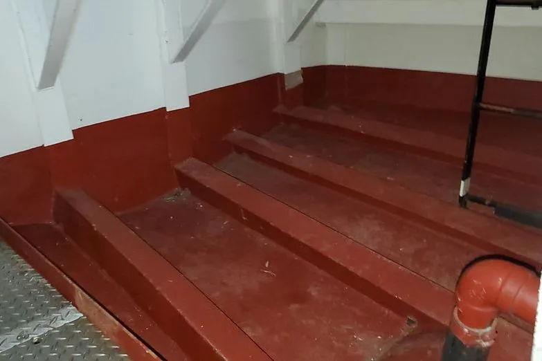 Slide: The Image of Interior of 1970 COMMERICAL BOAT LCU-135 showing red-painted metal steps and piping. - 11