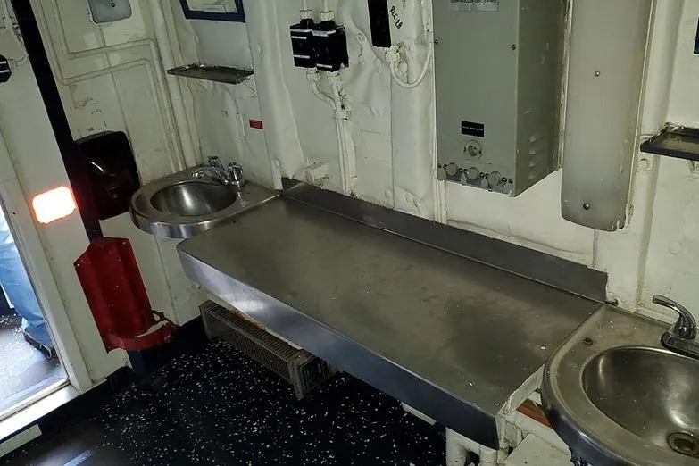 Slide: The Image of Interior of 1970 COMMERICAL BOAT LCU-135 with metal sinks and workbench. - 14