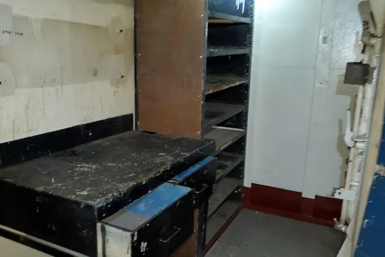 Slide: The Image of Interior of 1970 COMMERICAL BOAT LCU-135 with shelves and workbench. - 17