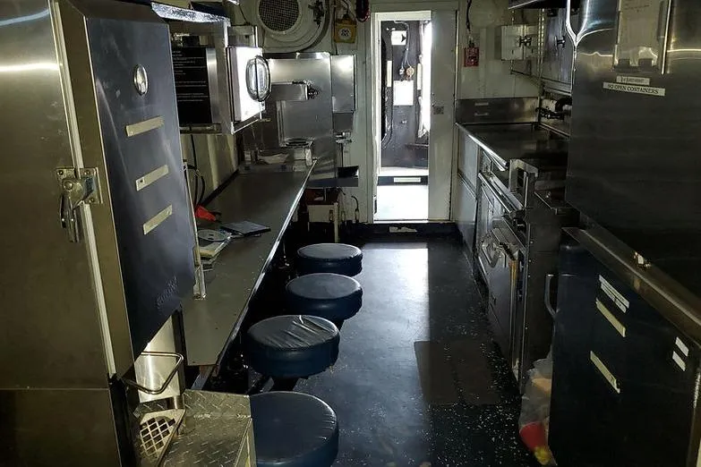 Slide: The Image of Interior of a 1970 COMMERICAL BOAT LCU-135 kitchen with stainless steel appliances. - 18