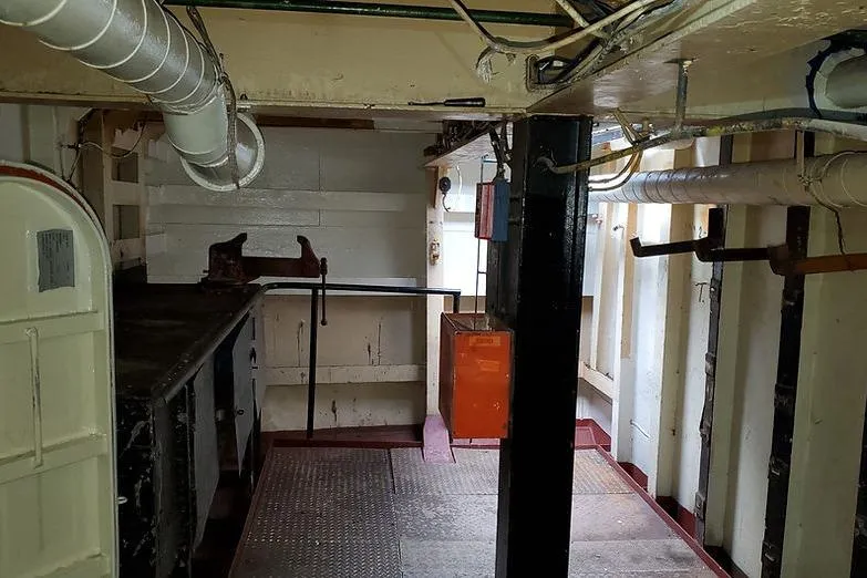 Slide: The Image of Interior of 1970 COMMERICAL BOAT LCU-135, featuring pipes and metal structures. - 19