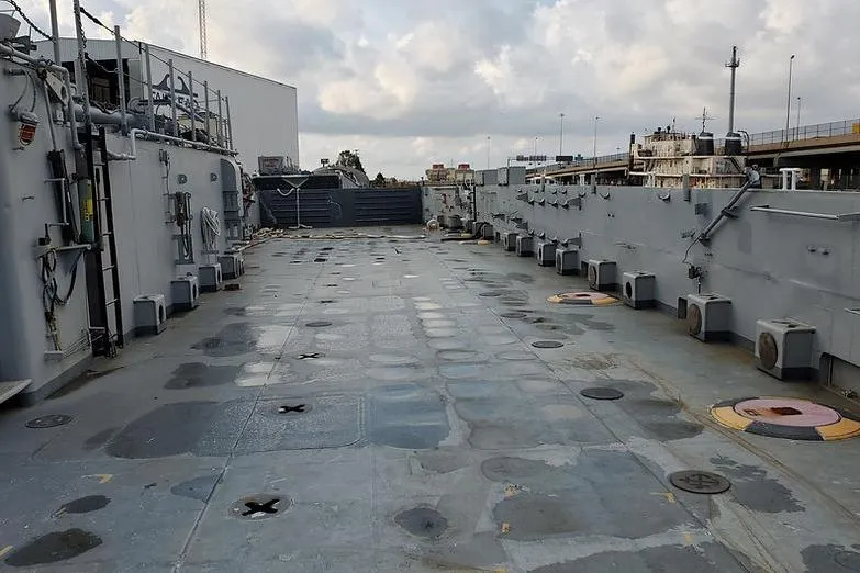 Slide: The Image of 1970 COMMERICAL BOAT LCU-135 deck with industrial equipment and cloudy sky. - 2
