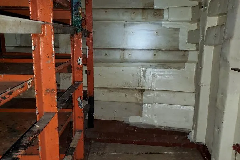 Slide: The Image of Interior of 1970 COMMERICAL BOAT LCU-135 with metal shelves and insulated walls. - 21