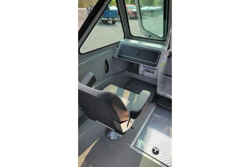 Slide: The Image of Interior of 2026 Smoker Craft Phantom 18 X2 boat, featuring a captain's chair and control panel. - 17