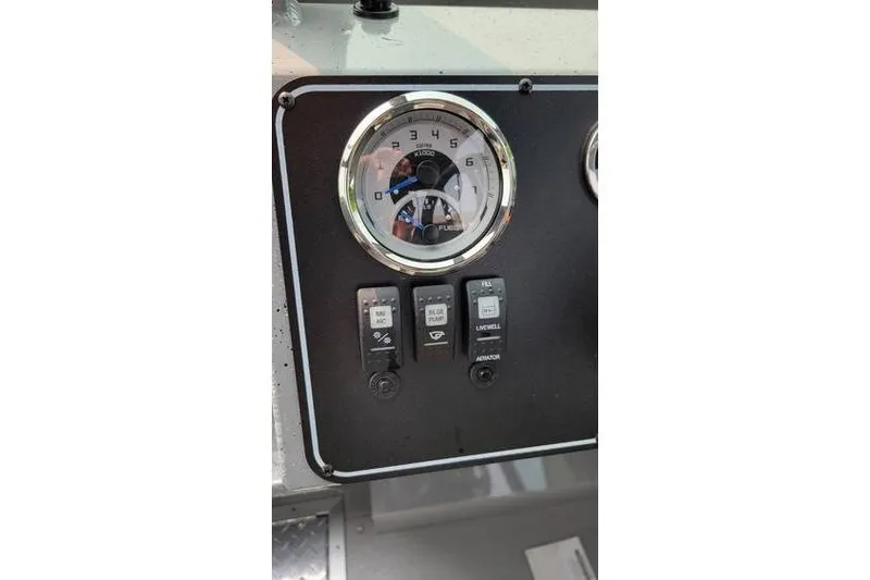 Slide: The Image of Dashboard of 2026 Smoker Craft Phantom 18 X2 boat with gauges and switches. - 18