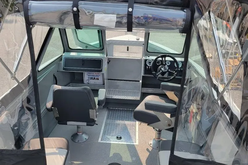 Slide: The Image of Interior of 2026 Smoker Craft Phantom 18 X2 boat with seating and steering wheel. - 25