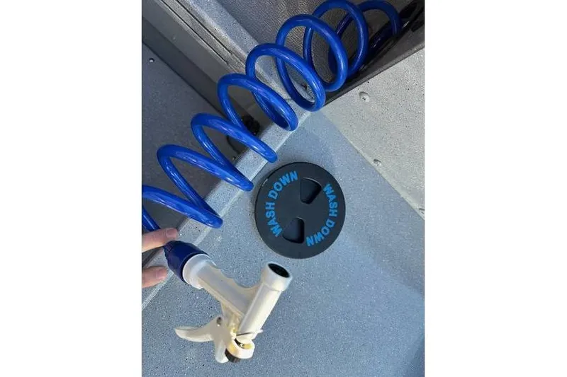 Slide: The Image of Blue washdown hose on Smoker Craft Phantom 18 X2 boat deck, 2026 model. - 5