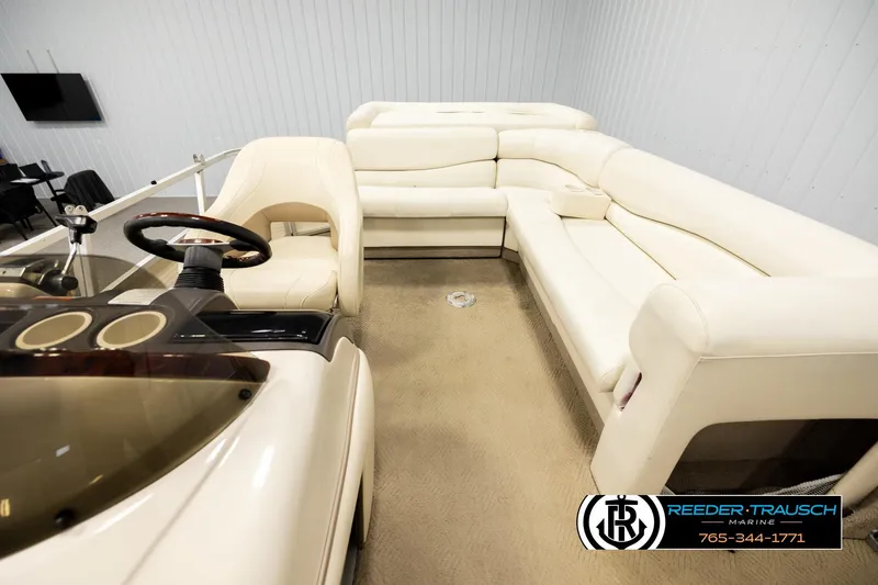 Slide: The Image of 2006 Sun Tracker Party Barge 22 Regency Edition interior with plush seating and steering console. - 13