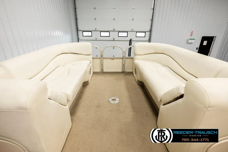 Slide: The Image of 2006 Sun Tracker Party Barge 22 Regency Edition with beige seating in a garage. - 17