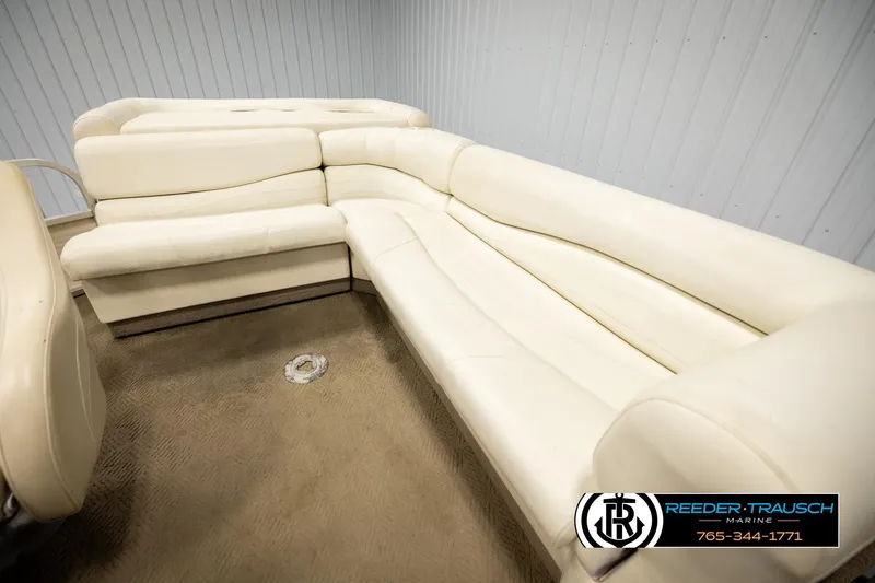 Slide: The Image of 2006 Sun Tracker Party Barge 22 Regency Edition with beige seating in a showroom. - 20