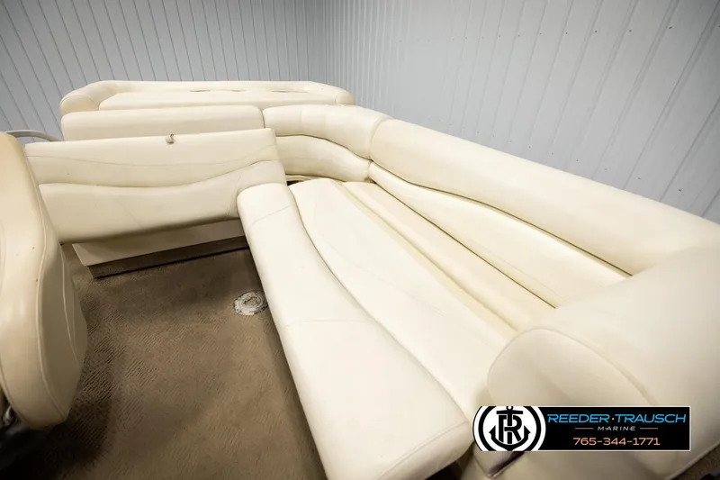 Slide: The Image of 2006 Sun Tracker Party Barge 22 Regency Edition with beige seating in a showroom. - 21