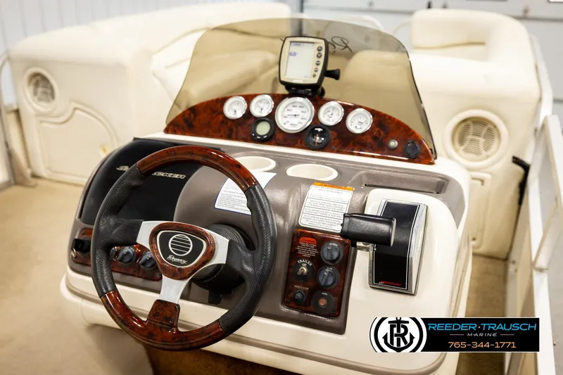Slide: The Image of 2006 Sun Tracker Party Barge 22 Regency Edition dashboard with steering wheel and controls. - 26