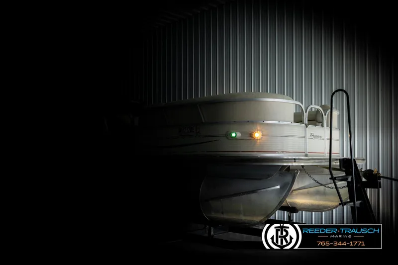 Slide: The Image of 2006 Sun Tracker Party Barge 22 Regency Edition in dimly lit storage facility. - 3