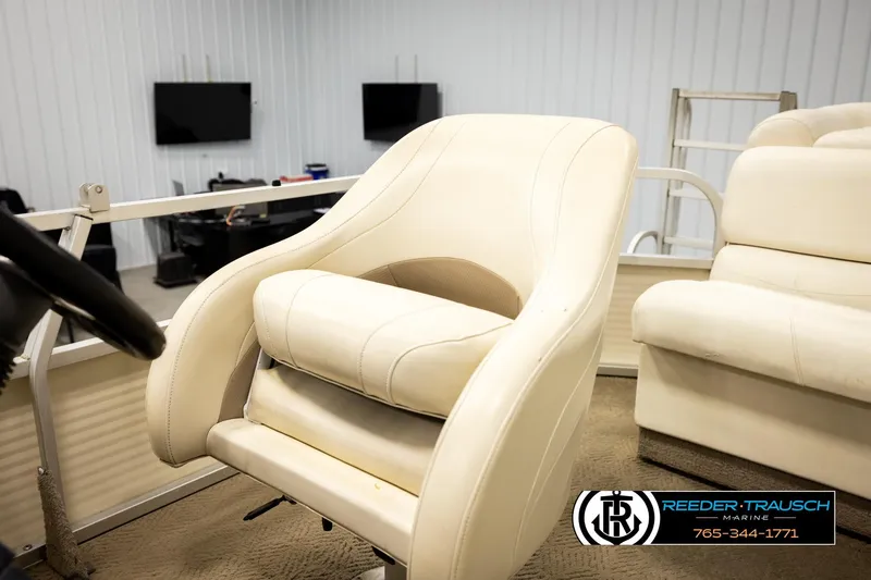 Slide: The Image of 2006 Sun Tracker Party Barge 22 Regency Edition interior with beige seating and steering wheel. - 35
