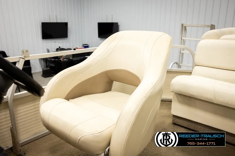 Slide: The Image of 2006 Sun Tracker Party Barge 22 Regency Edition interior with cream seating and steering wheel. - 36